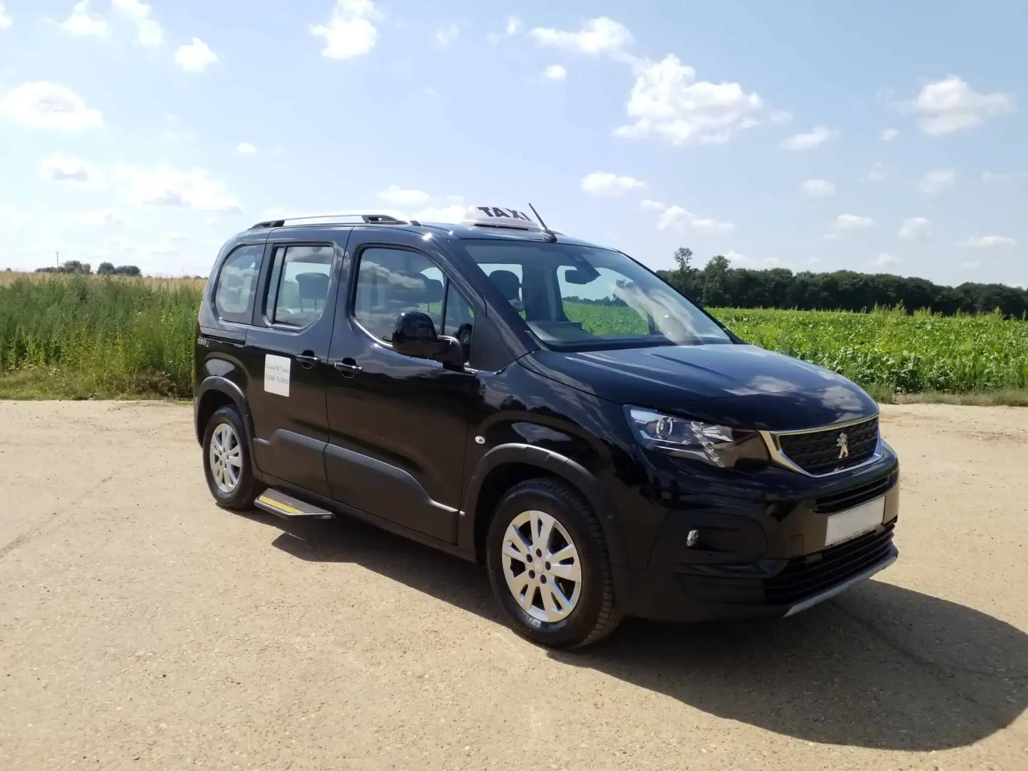 G and M Taxis vehicle with TAXI roof sign parked in rural Norfolk for Taxi for Hospital Downham Market journeys.