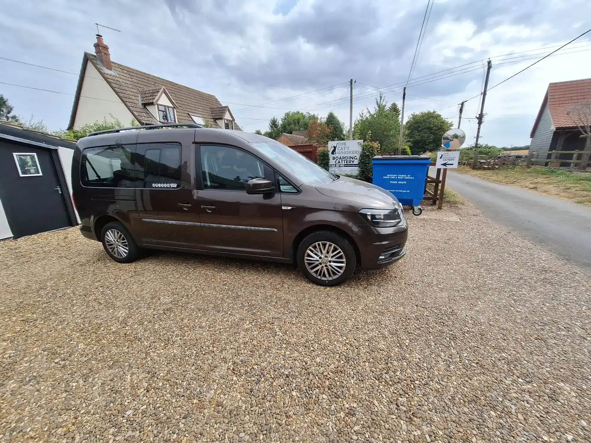 Brown G and M Taxis VW Caddy parked on a gravel driveway, used for Train Station Taxi in Downham Market and local village pickups.